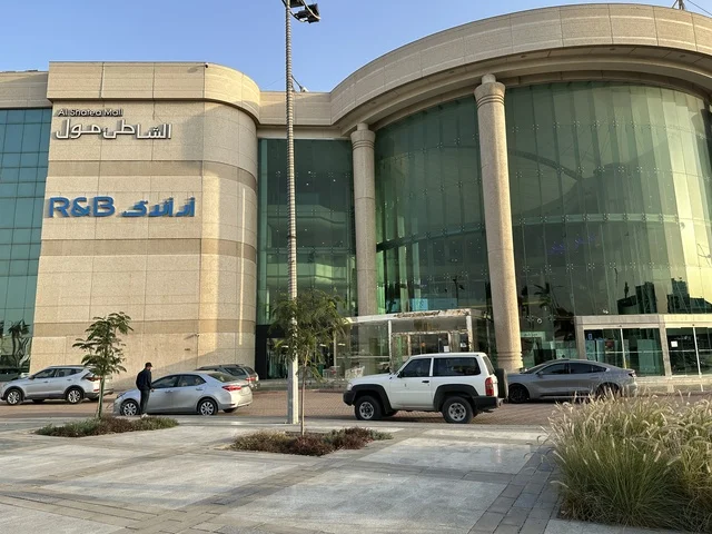 حركة مرور السيارات امام مدخل الشاطئ مول في مدينة الدمام، المنطقة الشرقية، المملكة العربية السعودية، مركز تجاري وترفيهي متكامل، مطاعم ومقاهي متنوعة،  مناطق ترفيهية للأطفال والعائلات، فعاليات موسمية وأنشطة تسويقية، متاجر وعلامات تجارية محلية وعالمية، أجواء عائلية لجميع الفئات.