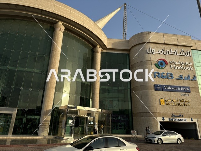 حركة مرور السيارات امام مدخل الشاطئ مول في مدينة الدمام، المنطقة الشرقية، المملكة العربية السعودية، مركز تجاري وترفيهي متكامل، مطاعم ومقاهي متنوعة،  مناطق ترفيهية للأطفال والعائلات، فعاليات موسمية وأنشطة تسويقية، متاجر وعلامات تجارية محلية وعالمية، أجواء عائلية لجميع الفئات.
