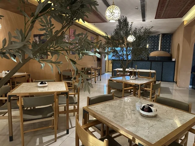 Elegant coffee seats at Al-Shatea Mall in Dammam City, Eastern Province, Saudi Arabia, a comprehensive commercial and entertainment center, diverse restaurants and cafes, recreational areas for children and families, seasonal events and marketing activities, local and international stores and brands, a family-friendly atmosphere for all categories.