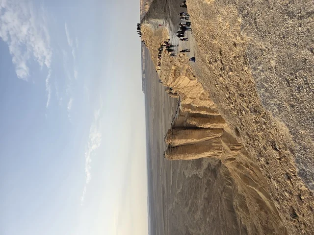 A natural view of the Edge of the World and the Grand Canyon overlook, the Tuwaiq Mountains in Riyadh, mountains in Najd in the Kingdom of Saudi Arabia, desert areas, rocky mountains and elevations, rocky peaks, historical landmarks, tourism in Saudi Arabia.