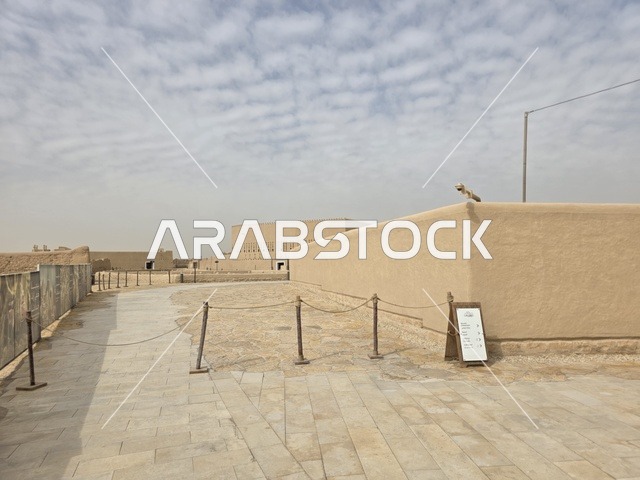 The dry desert and the cloudy sky, the history of the First Saudi State, the ancient walls of Diriyah in the city of Riyadh in the Kingdom of Saudi Arabia, ancient historical archaeological landmarks, ancient architectural engineering art, a picture of the archaeological buildings and mud houses in the Al-Turaif neighborhood in Diriyah.