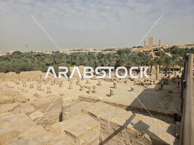 Clay structures built in the old style, green palm trees, the old walls of Diriyah in the city of Riyadh in the Kingdom of Saudi Arabia, ancient historical archaeological landmarks, ancient architectural engineering art, a picture of the archaeological buildings and clay houses in the Al-Turaif neighborhood in Diriyah.