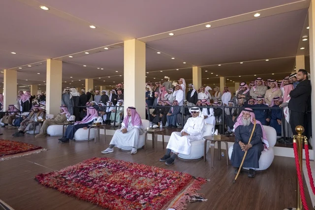 Expressions of enthusiasm and wide participation from camel owners, King Abdulaziz Camel Festival, Kingdom of Saudi Arabia, a major national heritage event, competitions and beauty of camels, shows and auctions, cultural and heritage activities, festive atmosphere reflecting the authenticity of the Saudi heritage.