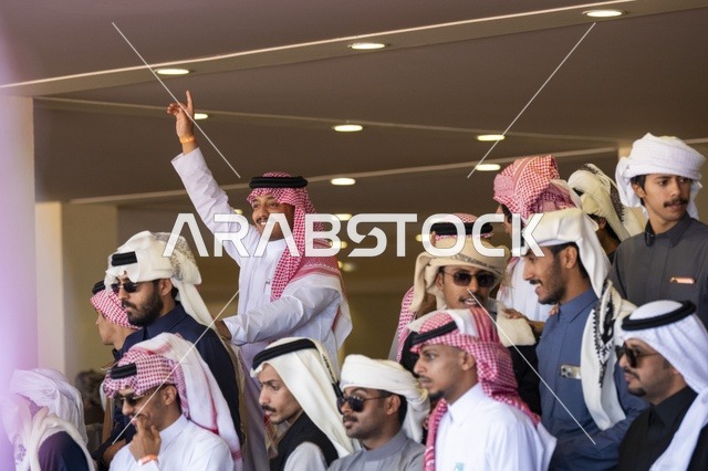 Expressions of enthusiasm and wide participation from camel owners, King Abdulaziz Camel Festival, Kingdom of Saudi Arabia, a major national heritage event, competitions and beauty of camels, shows and auctions, cultural and heritage activities, festive atmosphere reflecting the authenticity of the Saudi heritage.