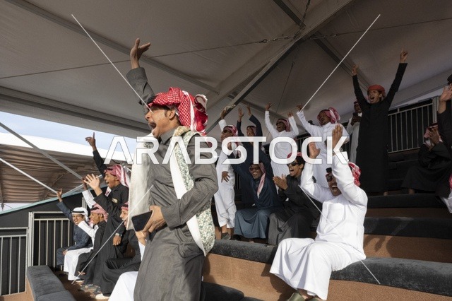 Expressions of enthusiasm and wide participation from camel owners, King Abdulaziz Camel Festival, Kingdom of Saudi Arabia, a major national heritage event, competitions and beauty of camels, shows and auctions, cultural and heritage activities, festive atmosphere reflecting the authenticity of the Saudi heritage.
