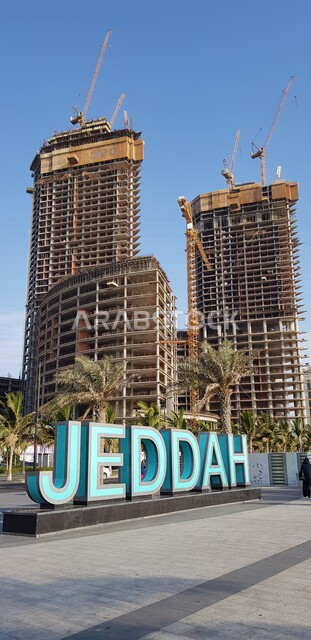An anthropomorphic word of Jeddah in English on the Jeddah Corniche, towers and skyscrapers in the city, the waterfront in the city of Jeddah, tourist attractions in the coastal city, Saudi Arabia