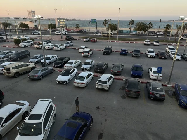 Parking in the outdoor parking lot of Marina Mall in Dammam, Eastern Province, Saudi Arabia, a shopping and entertainment center overlooking the waterfront, with various stores and brands, restaurants and cafes with sea views, recreational and service facilities, a family destination that combines shopping and entertainment.