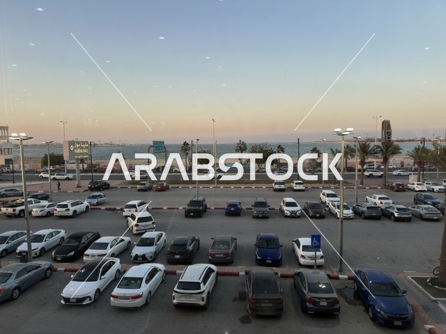 Parking in the outdoor parking lot of Marina Mall in Dammam, Eastern Province, Saudi Arabia, a shopping and entertainment center overlooking the waterfront, with various stores and brands, restaurants and cafes with sea views, recreational and service facilities, a family destination that combines shopping and entertainment.