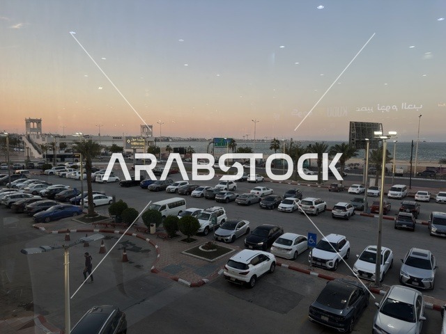 Parking in the outdoor parking lot of Marina Mall in Dammam, Eastern Province, Saudi Arabia, a shopping and entertainment center overlooking the waterfront, with various stores and brands, restaurants and cafes with sea views, recreational and service facilities, a family destination that combines shopping and entertainment.
