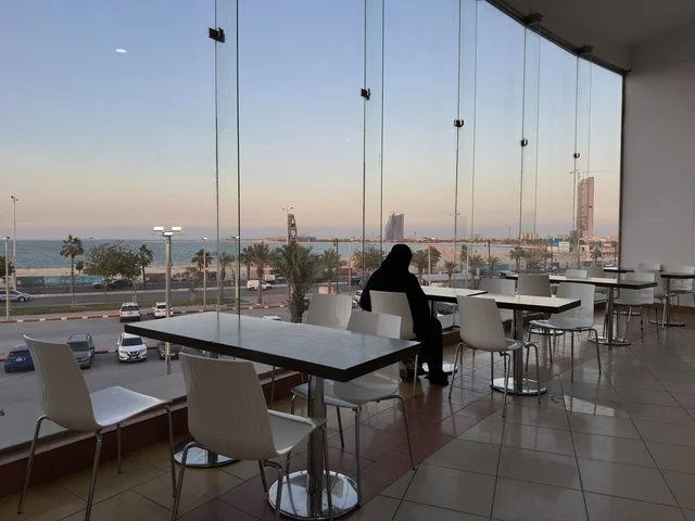 A view from the windows of a café in Marina Mall in Dammam, Eastern Province, Saudi Arabia, a shopping and entertainment center overlooking the waterfront, with various shops and brands, restaurants and cafés with sea views, recreational and service facilities, a family destination that combines shopping and entertainment.