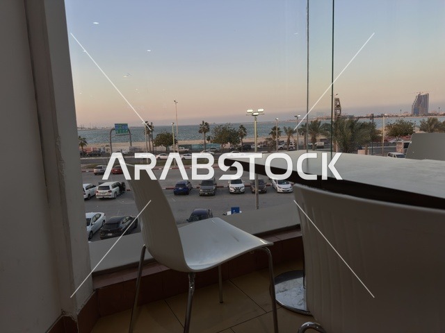 A view from the windows of a café in Marina Mall in Dammam, Eastern Province, Saudi Arabia, a shopping and entertainment center overlooking the waterfront, with various shops and brands, restaurants and cafés with sea views, recreational and service facilities, a family destination that combines shopping and entertainment.