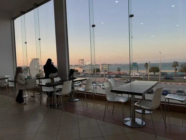 A view from the windows of a café in Marina Mall in Dammam, Eastern Province, Saudi Arabia, a shopping and entertainment center overlooking the waterfront, with various shops and brands, restaurants and cafés with sea views, recreational and service facilities, a family destination that combines shopping and entertainment.