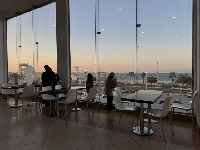 A view from the windows of a café in Marina Mall in Dammam, Eastern Province, Saudi Arabia, a shopping and entertainment center overlooking the waterfront, with various shops and brands, restaurants and cafés with sea views, recreational and service facilities, a family destination that combines shopping and entertainment.