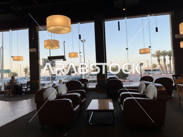 Seating for relaxation at one of the cafes in Marina Mall in Dammam, Eastern Province, Saudi Arabia, a shopping and entertainment center overlooking the waterfront, with diverse shops and brands, restaurants and cafes with sea views, recreational and service facilities, a family destination that combines shopping and entertainment.