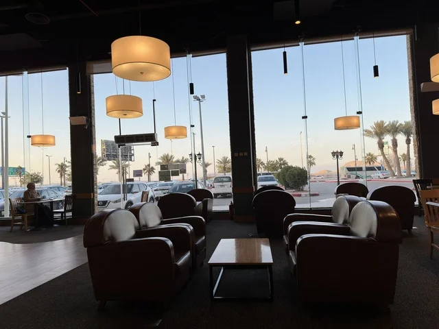 Seating for relaxation at one of the cafes in Marina Mall in Dammam, Eastern Province, Saudi Arabia, a shopping and entertainment center overlooking the waterfront, with diverse shops and brands, restaurants and cafes with sea views, recreational and service facilities, a family destination that combines shopping and entertainment.