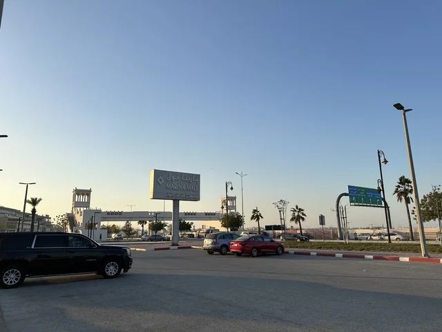 Parking for cars in the outdoor lots of Marina Mall in Dammam, Eastern Province, Saudi Arabia, a shopping and entertainment center overlooking the waterfront, with various stores and brands, restaurants and cafes with sea views, recreational and service facilities, a family destination that combines shopping and entertainment.