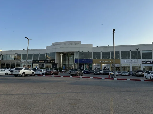 Parking for cars in the outdoor lots of Marina Mall in Dammam, Eastern Province, Saudi Arabia, a shopping and entertainment center overlooking the waterfront, with various stores and brands, restaurants and cafes with sea views, recreational and service facilities, a family destination that combines shopping and entertainment.
