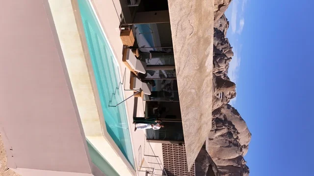A mountain resort integrated with the rocky nature, Desert Rock in the Kingdom of Saudi Arabia, features an innovative architectural design carved into the mountains, offering a unique tourism experience that combines luxury and sustainability, with stunning desert views, making it a global tourist destination.