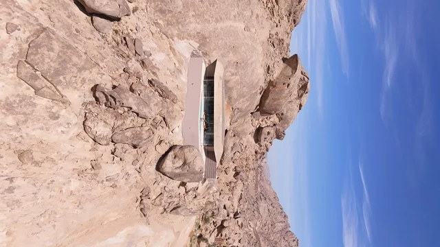 A mountain resort integrated with the rocky nature, Desert Rock in the Kingdom of Saudi Arabia, features an innovative architectural design carved into the mountains, offering a unique tourism experience that combines luxury and sustainability, with stunning desert views, making it a global tourist destination.