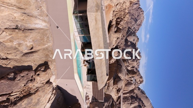 A global tourist destination, a mountain resort integrated with the rocky nature, Desert Rock in the Kingdom of Saudi Arabia, features innovative architectural design carved into the mountains, offering a unique tourism experience that combines luxury and sustainability, with stunning desert views.