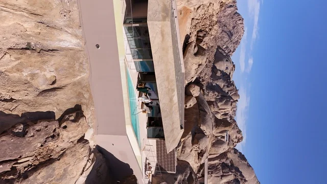 A global tourist destination, a mountain resort integrated with the rocky nature, Desert Rock in the Kingdom of Saudi Arabia, features innovative architectural design carved into the mountains, offering a unique tourism experience that combines luxury and sustainability, with stunning desert views.