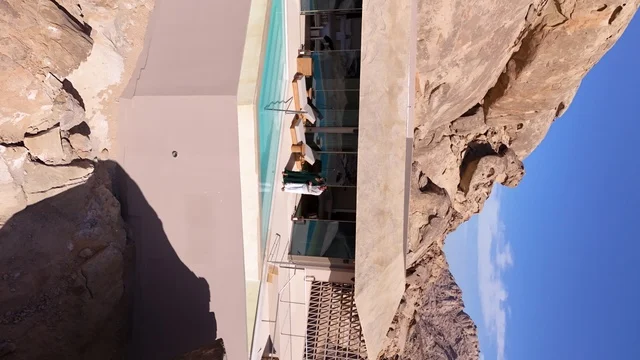 A global tourist destination, a mountain resort integrated with the rocky nature, Desert Rock in the Kingdom of Saudi Arabia, features innovative architectural design carved into the mountains, offering a unique tourism experience that combines luxury and sustainability, with stunning desert views.