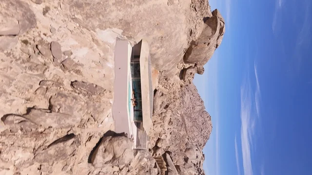 A global tourist destination, a mountain resort integrated with the rocky nature, Desert Rock in the Kingdom of Saudi Arabia, features innovative architectural design carved into the mountains, offering a unique tourism experience that combines luxury and sustainability, with stunning desert views.