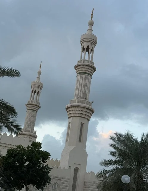 The minarets of Sheikh Zayed Mosque in Ajman, United Arab Emirates, winter atmosphere with a view of the cloudy sky, architectural art, tranquility, and spirituality. The minarets of Sheikh Zayed Mosque in Ajman, United Arab Emirates, winter atmosphere with a view of the cloudy sky, architectural art, tranquility, and spirituality.