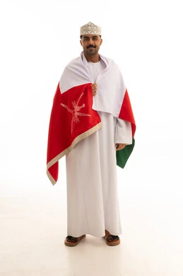 Omani Man in Traditional Dress with National Flag