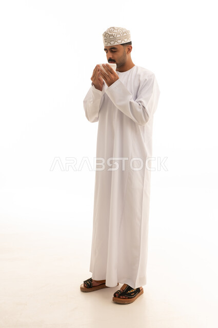 Omani Man in Traditional Dishdasha with White Cup