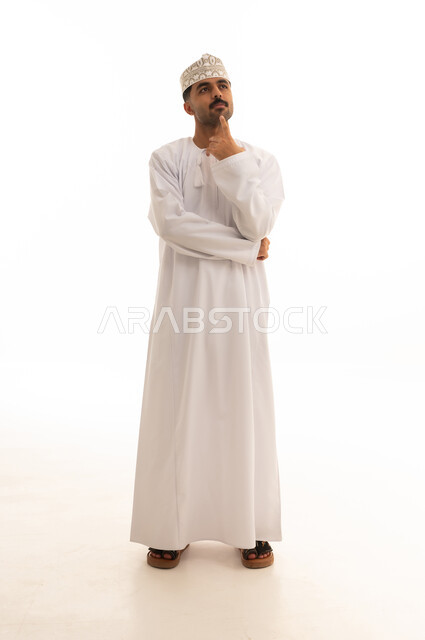 Omani Man Thinking in Traditional White Dishdasha