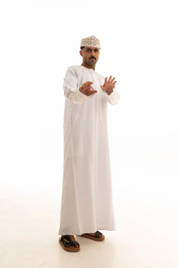 Omani Man in White Dishdasha Making Stop Gesture