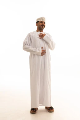رجل عماني يبتسم بالزي التقليدي والدشداشة البيضاء