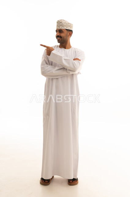 Smiling Omani Man Pointing Side on White Background