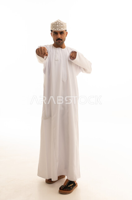 Omani Man in Traditional Dishdasha Pointing Forward