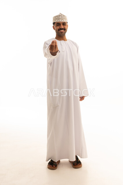 Omani Man in Traditional Dress with Hand Gesture