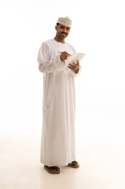Omani Man in Traditional Dress Writing on White Background