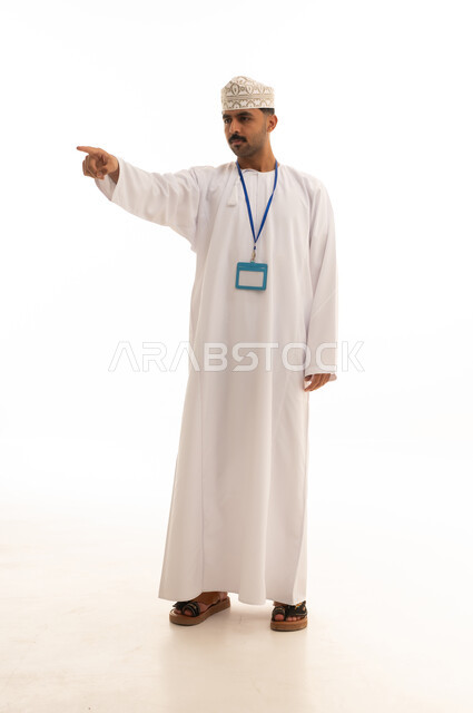 Omani Man in Traditional Dress Pointing on White Background