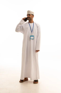 Omani Man in Traditional Dress Talking on Smartphone