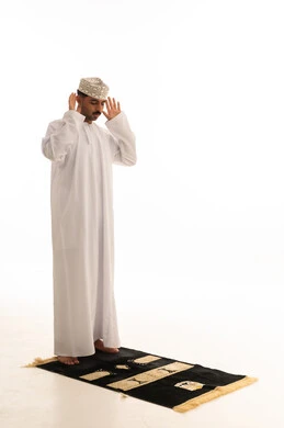 Omani Man Praying in Traditional Dress on White Background