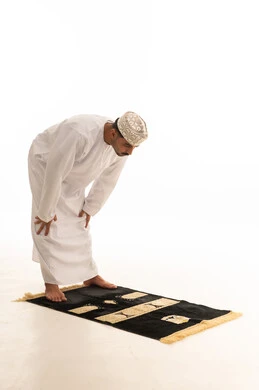 رجل عماني في وضعية الركوع بخلفية بيضاء