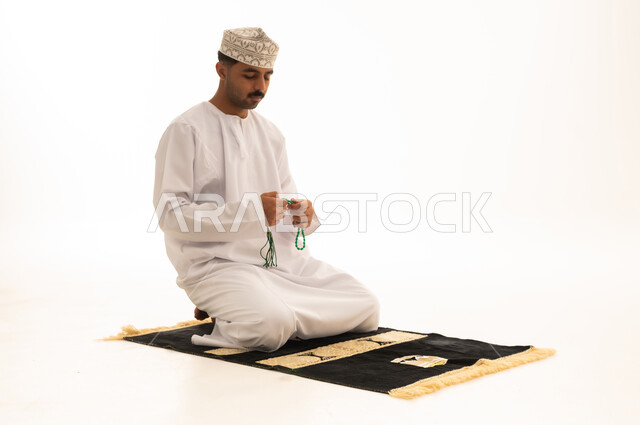 Omani Man Praying with Misbaha on White Background