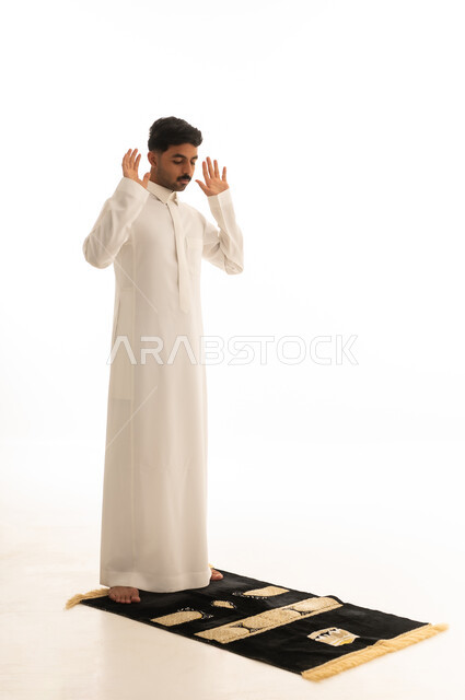 Saudi Man Performing Takbir on Prayer Mat