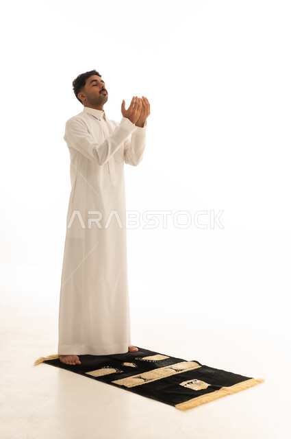 Saudi Man in Thobe Praying on White Background