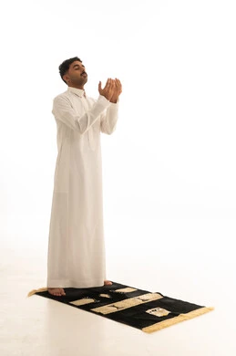 Saudi Man in Thobe Praying on White Background