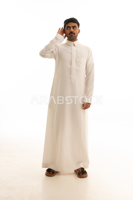 رجل سعودي بالثوب يستمع على خلفية بيضاء