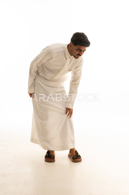 رجل سعودي بالثوب يشعر بألم في الساق خلفية بيضاء