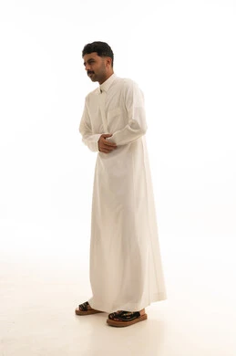Saudi Man in White Thobe with Stomach Pain