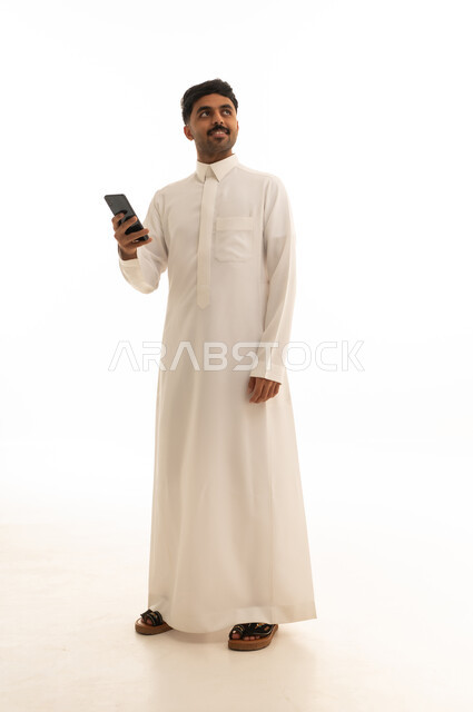 Saudi Man in Traditional Thobe Holding Smartphone