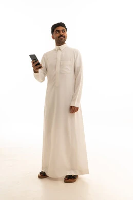 Saudi Man in Traditional Thobe Holding Smartphone